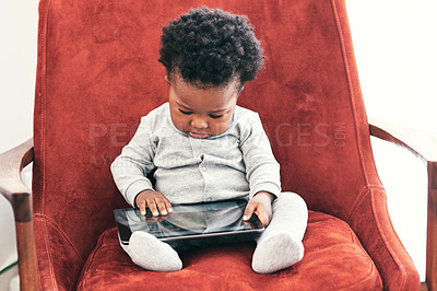 Buy stock photo Baby, boy and online with tablet on sofa with digital learning for early childhood or cognitive development and growth. Toddler, technology and relax in home with sensory app or game for motor skills
