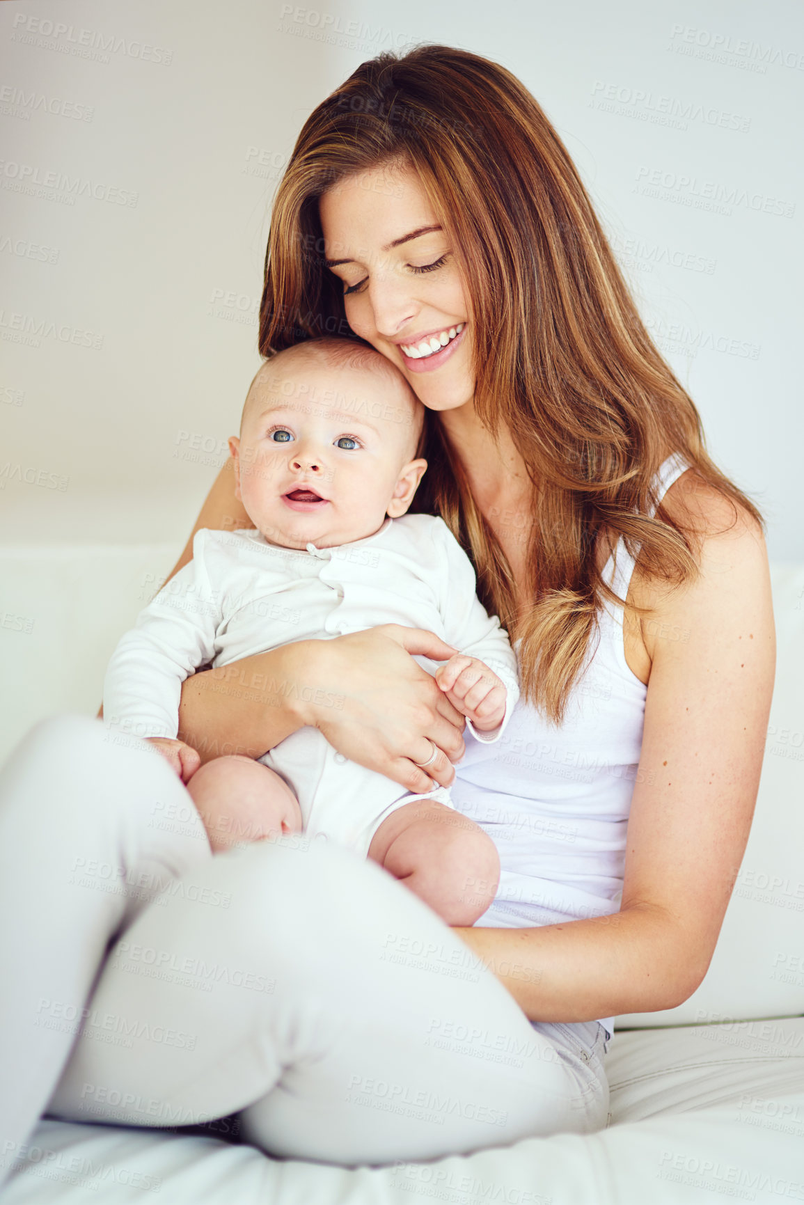 Buy stock photo Shot of a young mother bonding with her adorable baby boy at home