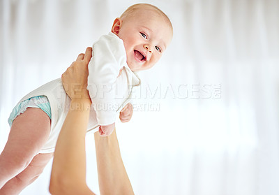Buy stock photo Cropped shot of a baby boy being held by his parent at home