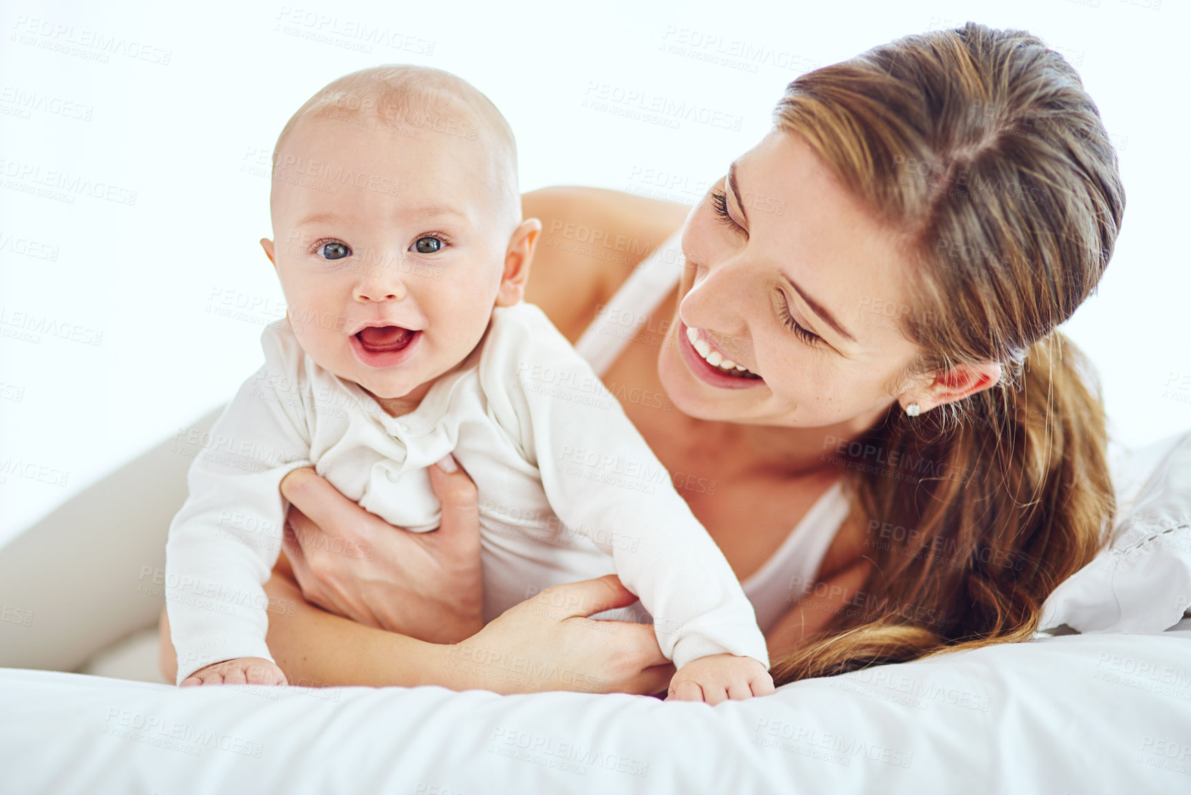 Buy stock photo Shot of a young mother bonding with her adorable baby boy at home