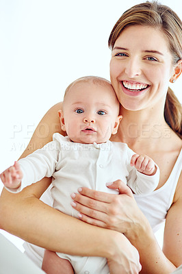 Buy stock photo Portrait of a loving mother carrying her baby boy at home