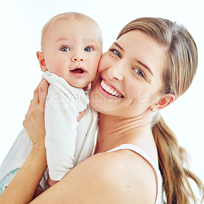Buy stock photo Portrait of a loving mother carrying her baby boy at home