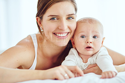 Buy stock photo Portrait of happy and loving mother bonding with her cute baby boy at home while enjoying parenthood. Single parent being playful and affectionate, embracing precious moments with her newborn child


