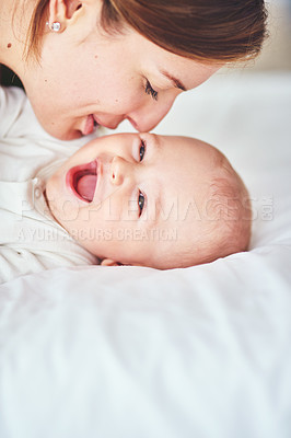 Buy stock photo Shot of a young mother bonding with her adorable baby boy at home