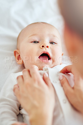 Buy stock photo Shot of a young mother bonding with her adorable baby boy at home