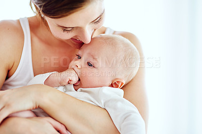 Buy stock photo Shot of an adorable baby boy bonding with his mother at home