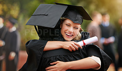 Buy stock photo Two college graduates hugging one another in congratulations