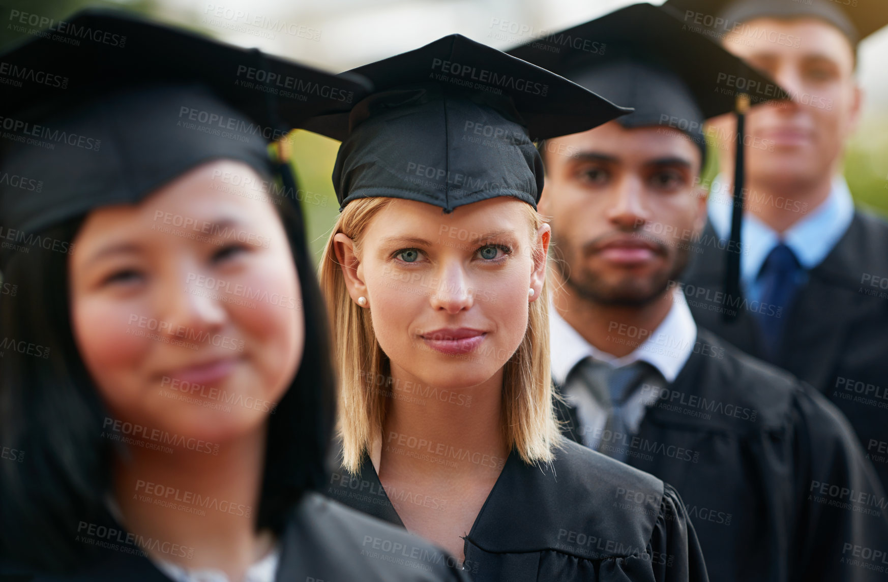 Buy stock photo Portrait, graduation and woman student in row with friends for university or college ceremony outdoor. Face, education and scholarship with serious young person on campus for success or achievement