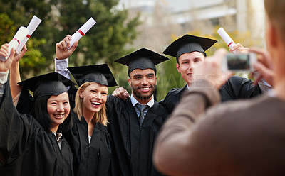 Buy stock photo Graduation, success and photograph of student friends outdoor on campus at university or college. Education, certificate and achievement with group of young graduate people together for picture