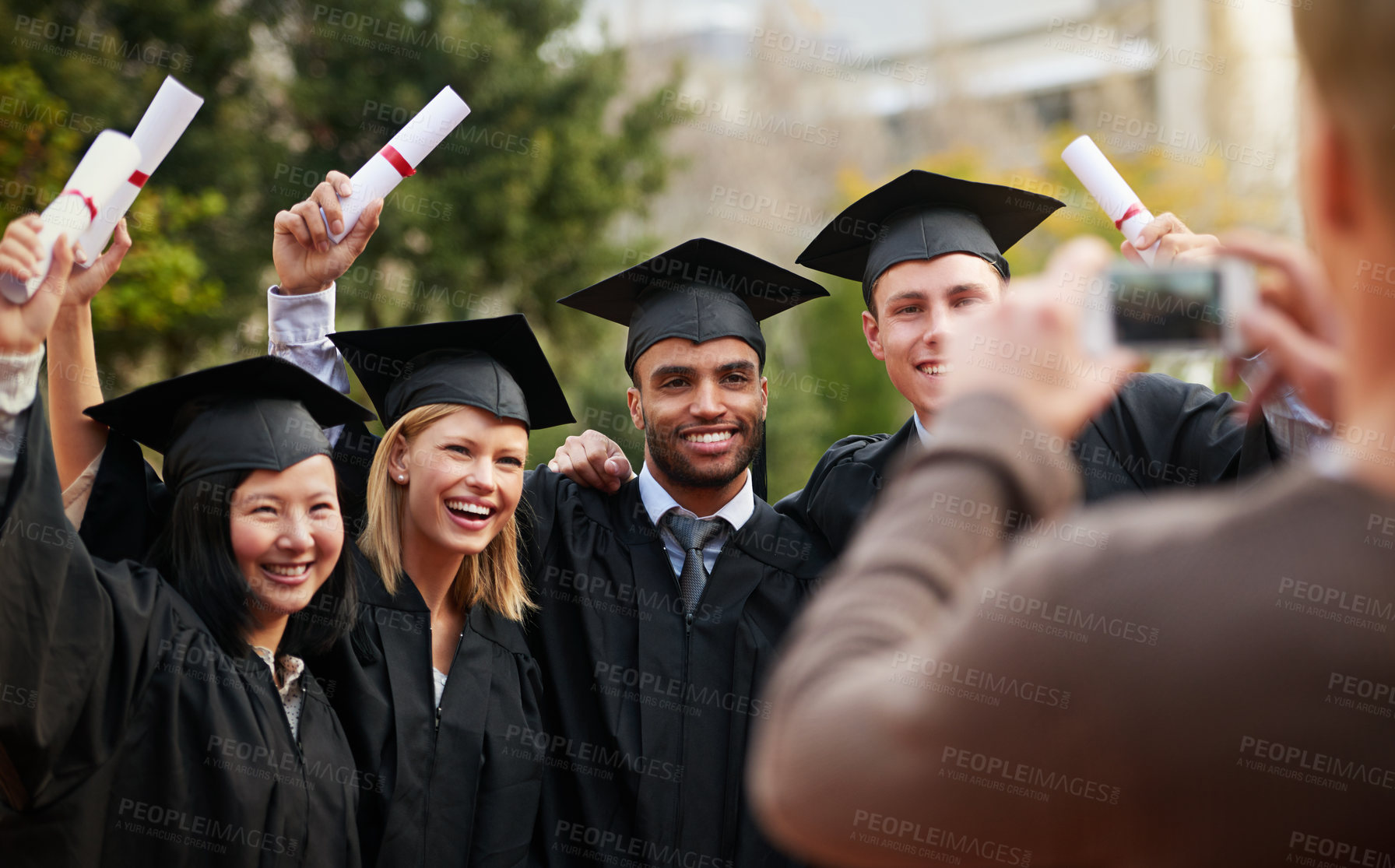 Buy stock photo Graduation, success and photograph of student friends outdoor on campus at university or college. Education, certificate and achievement with group of young graduate people together for picture