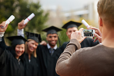 Buy stock photo Graduation, certificate and photograph of student friends outdoor on campus at university or college. Education, hands and success with group of young graduate people cheering together for picture
