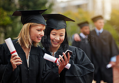Buy stock photo Graduation, certificate and phone with student friends outdoor on campus for university or college event. Mobile, communication and smile with young graduate women at school for higher education