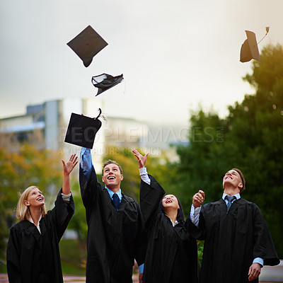 Buy stock photo Graduation, mortar in air and student friends outdoor on campus for celebration at university ceremony. Education, winner and throw with graduate group together at college for success or achievement 