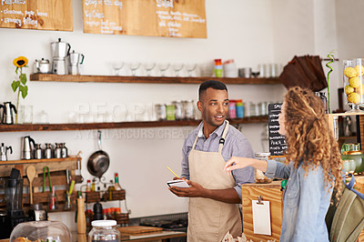 Buy stock photo Customer, coffee shop and barista with writing at counter for order, purchase and breakfast at cafe. Female person, small business and waiter with notepad for discussion, help and food service