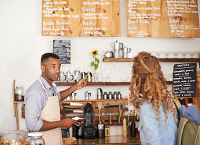 Buy stock photo Woman, coffee shop and waiter with pointing at menu for customer, purchase and decision in cafe. Barista, small business and lady in restaurant with help, shopping and choice for lunch order