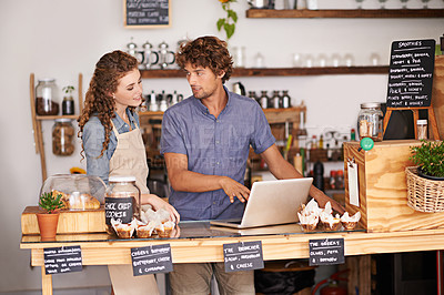 Buy stock photo Computer, bakery and small business people with team for  of sales, planning and advice in startup. Young woman and man or water in review for inventory, profit and e commerce on laptop at cafe
