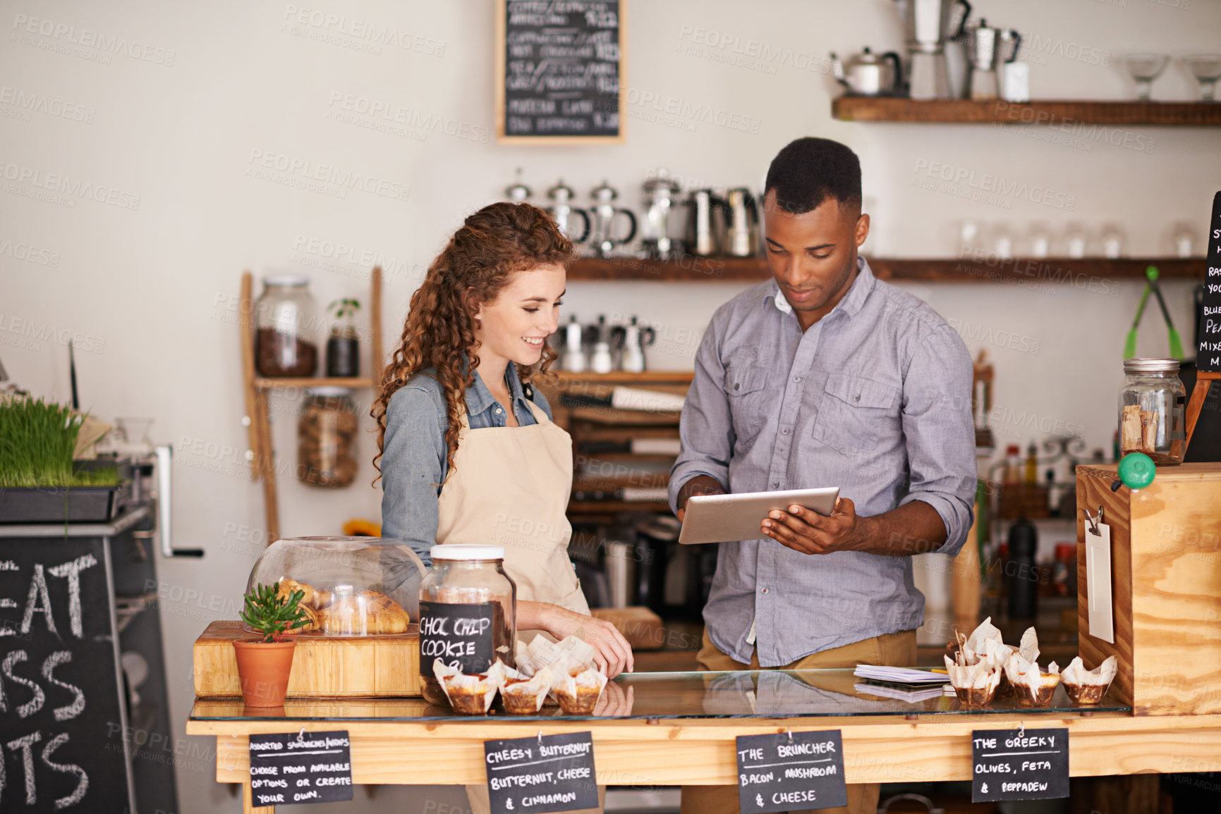 Buy stock photo Tablet, restaurant and owner in teamwork of people, discussion and manage orders in store. Waiters, black man and happy woman in cafe with technology for inventory, stock check and managing sales.