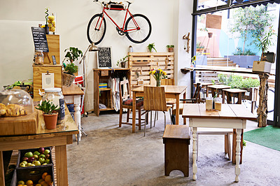 Buy stock photo Empty, coffee shop and interior space with table, chairs and furniture or small business, bistro and cafe with unique design and style. Background, creative startup and food store with bike on wall