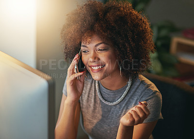 Buy stock photo Shot of a young woman talking on the phone during a late shift at the office