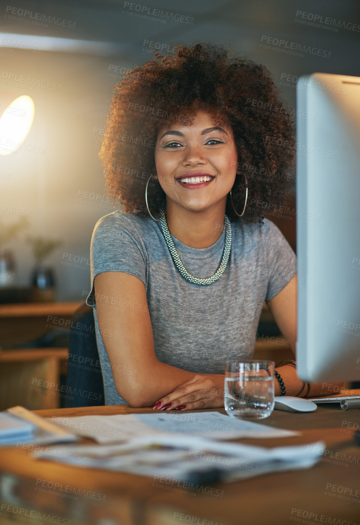 Buy stock photo Night, portrait and woman on computer in office  working at desk for administration deadline. African, afro or confident designer on desktop in creative workplace for evening report or research