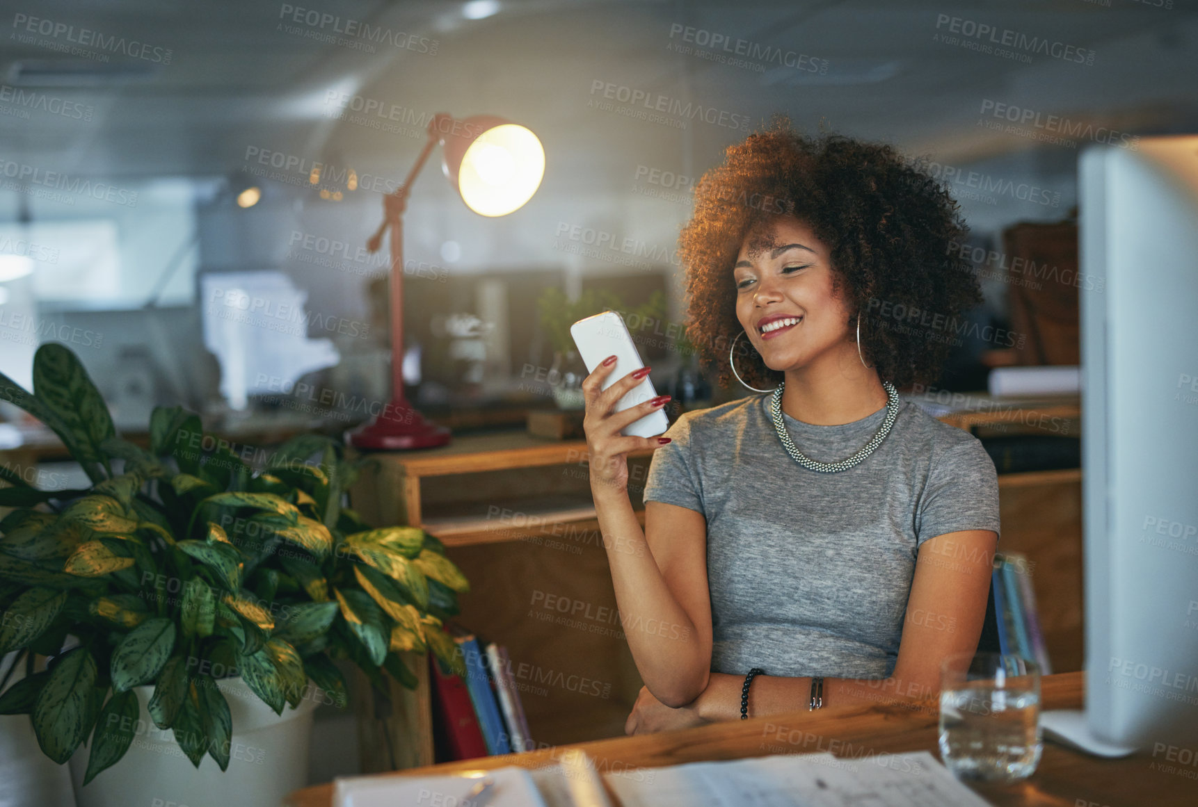 Buy stock photo Night, creative and woman at desk with phone, smile and search on social media website for networking. Smartphone, scroll and designer on mobile app for article, email or online chat in dark office