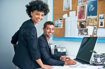 Buy stock photo Portrait of two coworkers working together at a computer in an office