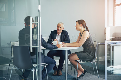 Buy stock photo Shot of a group of businesspeople having a meeting together in an office