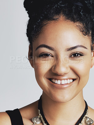 Buy stock photo Studio portrait of a happy young woman posing against a grey background