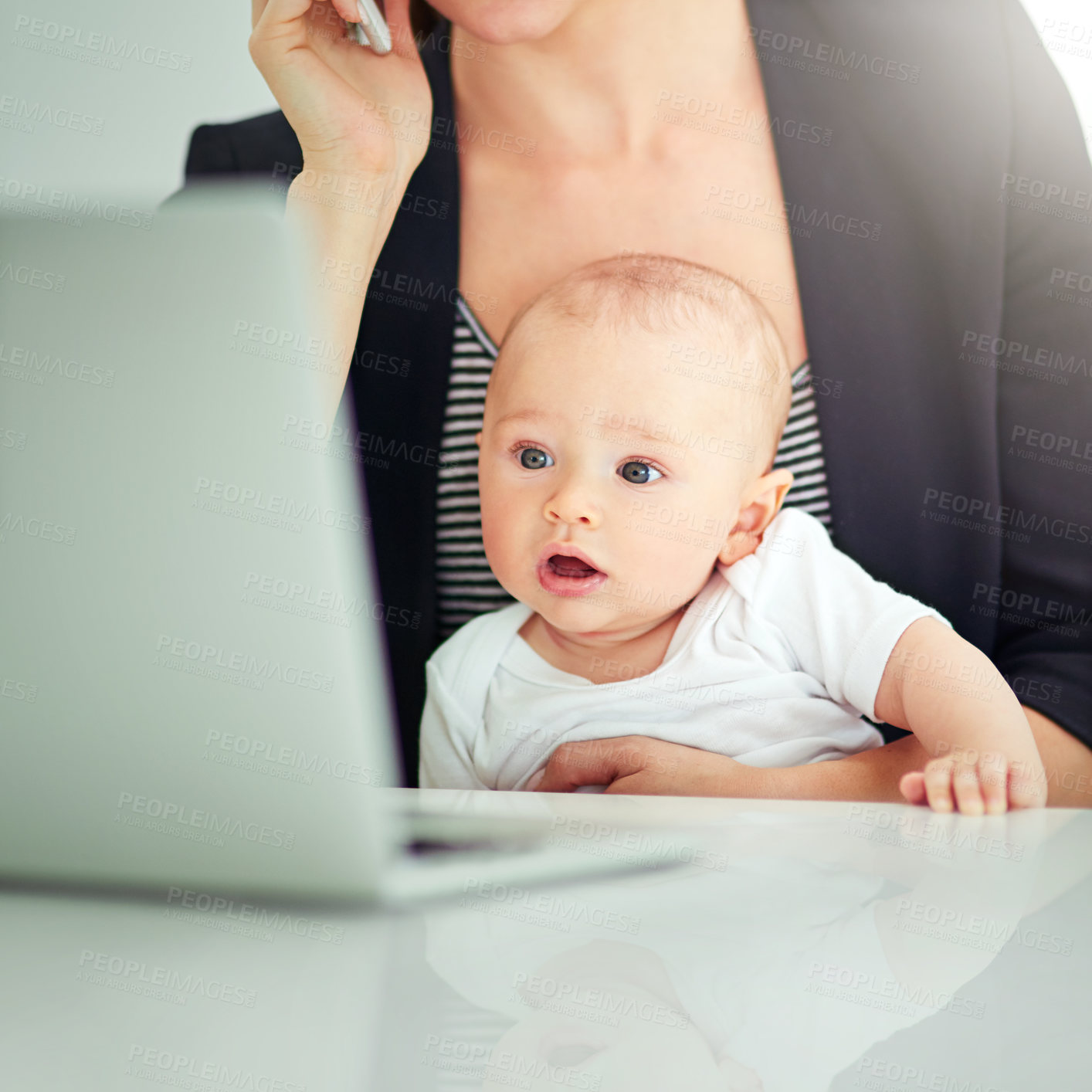 Buy stock photo Shot of an adorable baby boy curious about his mother’s work on her computer