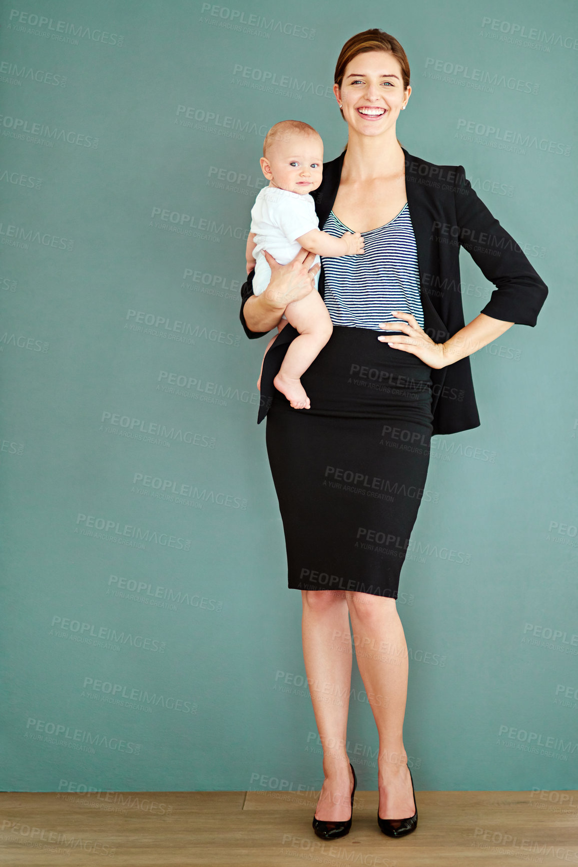 Buy stock photo Studio shot of a successful young businesswoman carrying her adorable baby boy