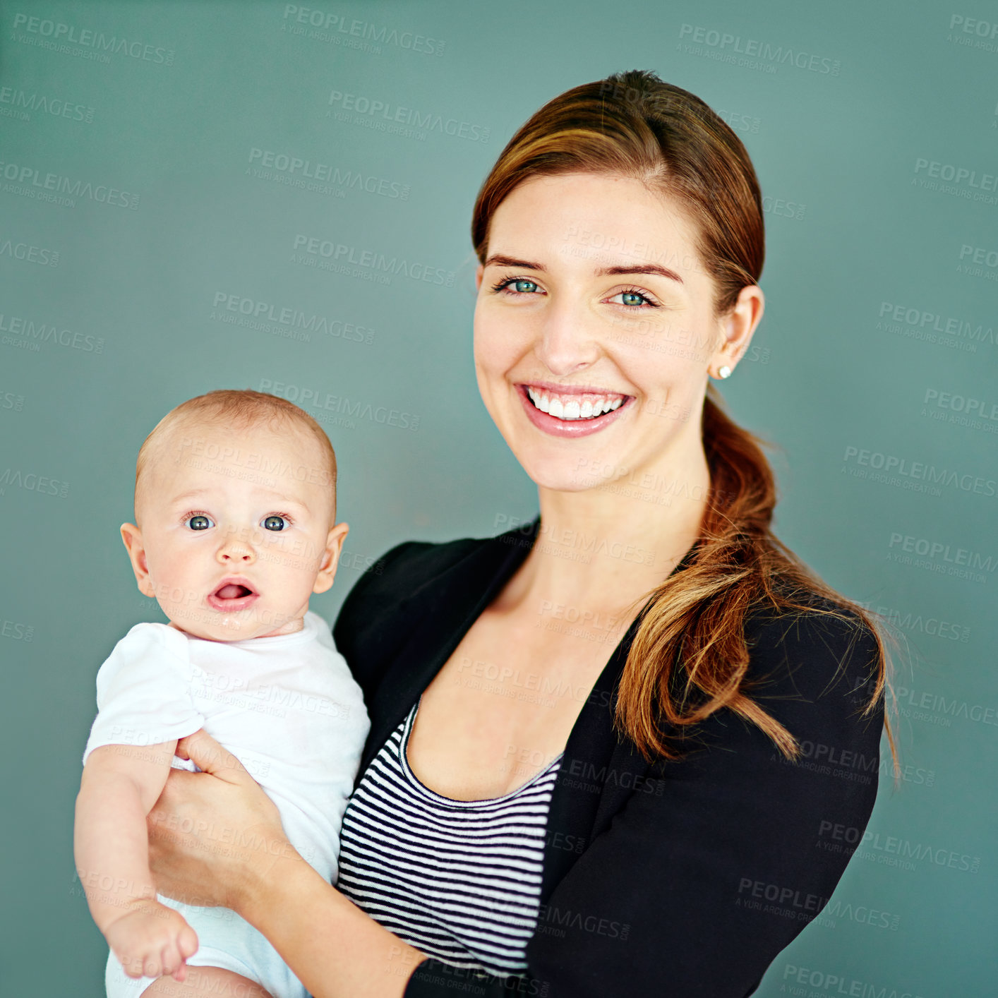 Buy stock photo Business woman, baby and happy in studio for motherhood, ambition or bonding with background. Lawyer, portrait and carrying child with pride for support, responsibility and single mother with smile