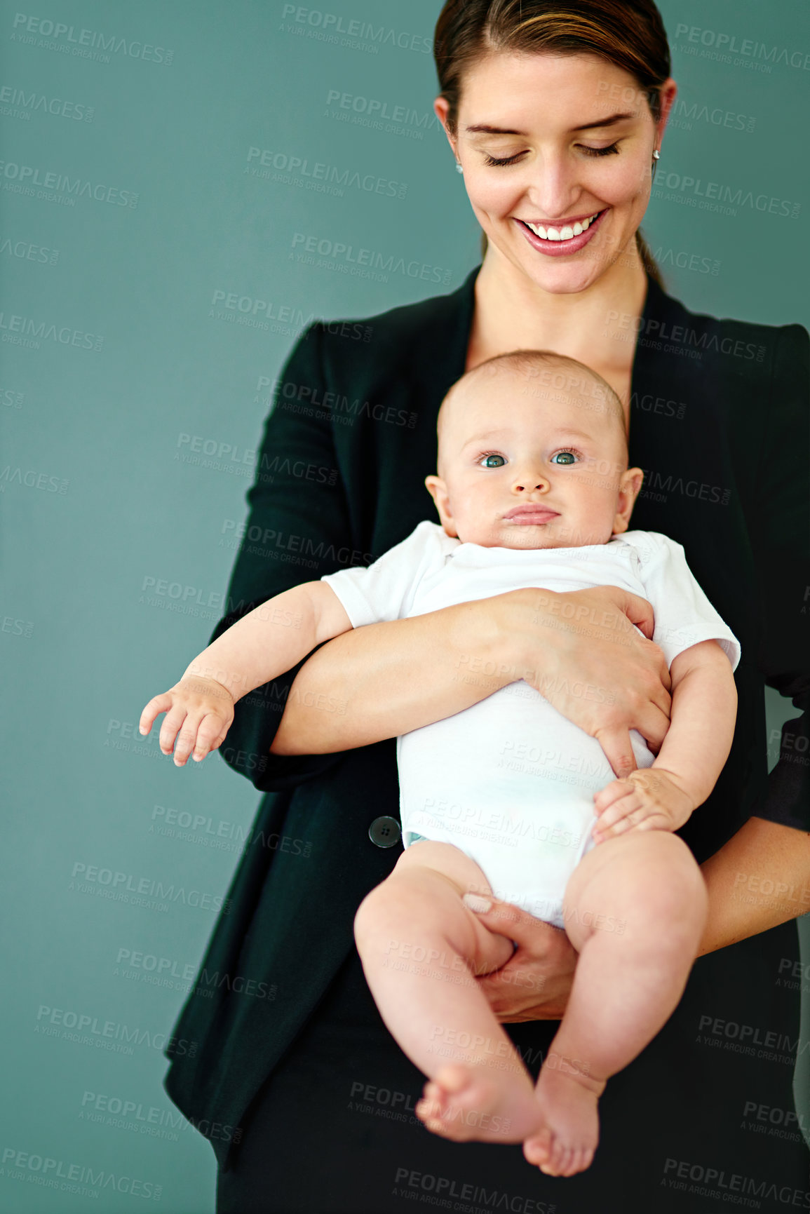 Buy stock photo Studio shot of a successful young businesswoman carrying her adorable baby boy