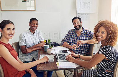 Buy stock photo Portrait of a group of colleagues working together at a desk in an office