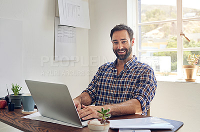 Buy stock photo Portrait of a smiling man sitting at a desk working on a laptop