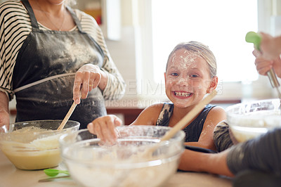 Buy stock photo Portrait, playing or messy girl baking in kitchen with a young kid smiling with flour on a dirty face at home. Smile, happy or parent cooking or teaching a fun daughter to bake for child development 