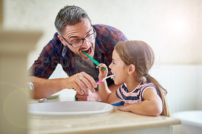 Buy stock photo Kid, father and brushing teeth in bathroom, bonding and cleaning together. Dad, girl and toothbrush for dental hygiene, oral wellness or health for happy family care, teaching and learning at home.