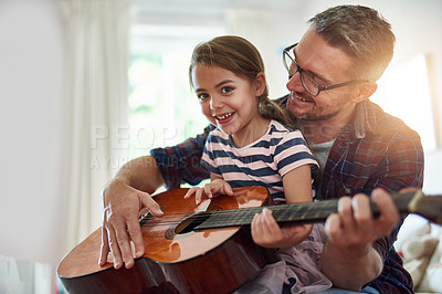 Buy stock photo Father, guitar and teaching a girl in portrait with happiness at home for fun or love or bonding. Music, acoustic and instrument with parent and daughter for learning or care with music together.