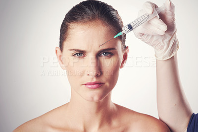 Buy stock photo Woman, portrait and hand with injection in forehead or wrinkles plastic surgery, cosmetics or face lift. Female person, needle and frown lines for anti aging in studio, white background or mockup