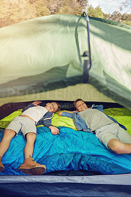 Buy stock photo Cropped shot of two young brothers lying in their tent