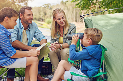 Buy stock photo Cropped shot of a family of four camping in the woods