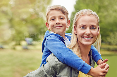 Buy stock photo Cropped portrait of a mother piggybacking her young son out in the woods