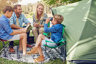 Buy stock photo Cropped shot of a family of four camping in the woods