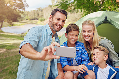 Buy stock photo Cropped shot of a family of four taking a selfie while camping