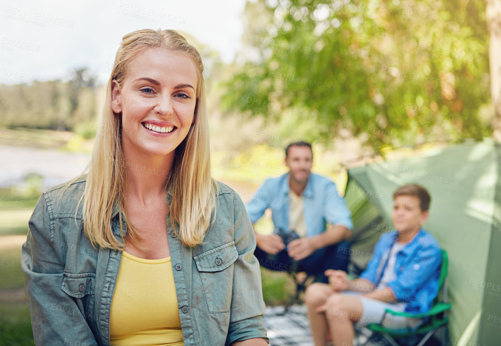 Buy stock photo Cropped shot of a family of three camping in the woods