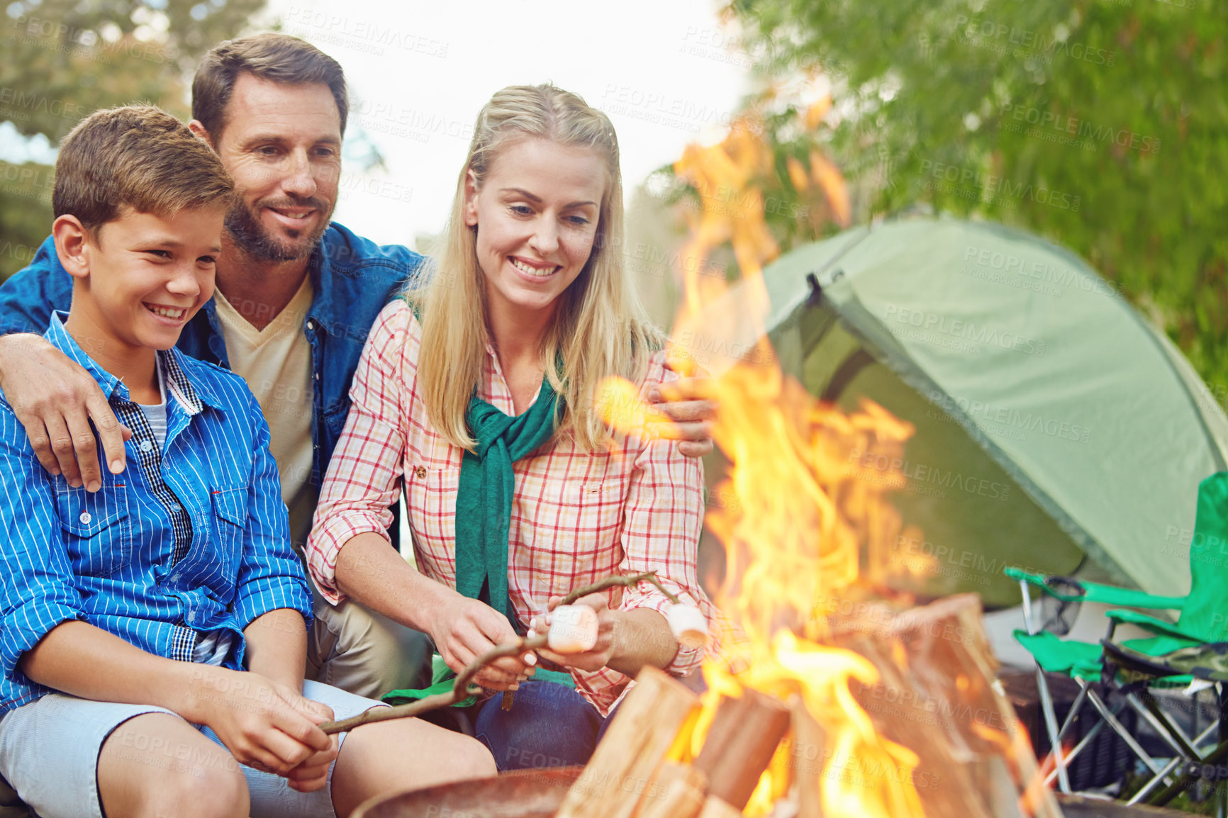 Buy stock photo Cropped shot of a family of three camping in the woods