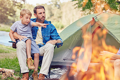Buy stock photo Shot of a father and his son out camping in the woods