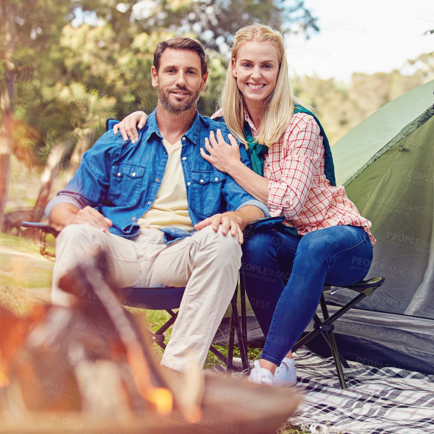 Buy stock photo Portrait of an affectionate couple camping out in the woods