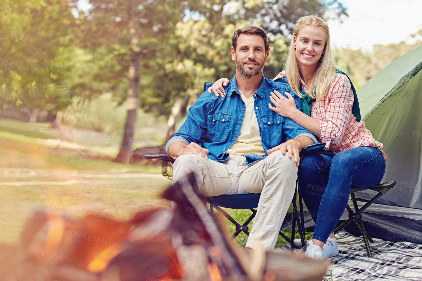 Buy stock photo Portrait of an affectionate couple camping out in the woods