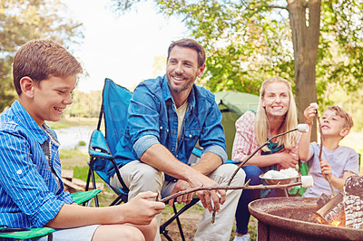 Buy stock photo Cropped shot of a family of four camping in the woods