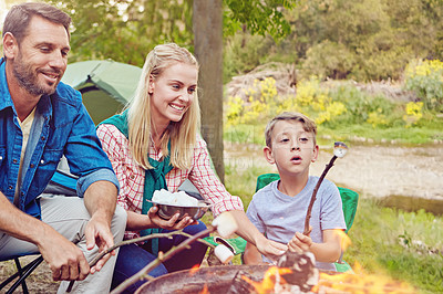 Buy stock photo Cropped shot of a family of three camping in the woods